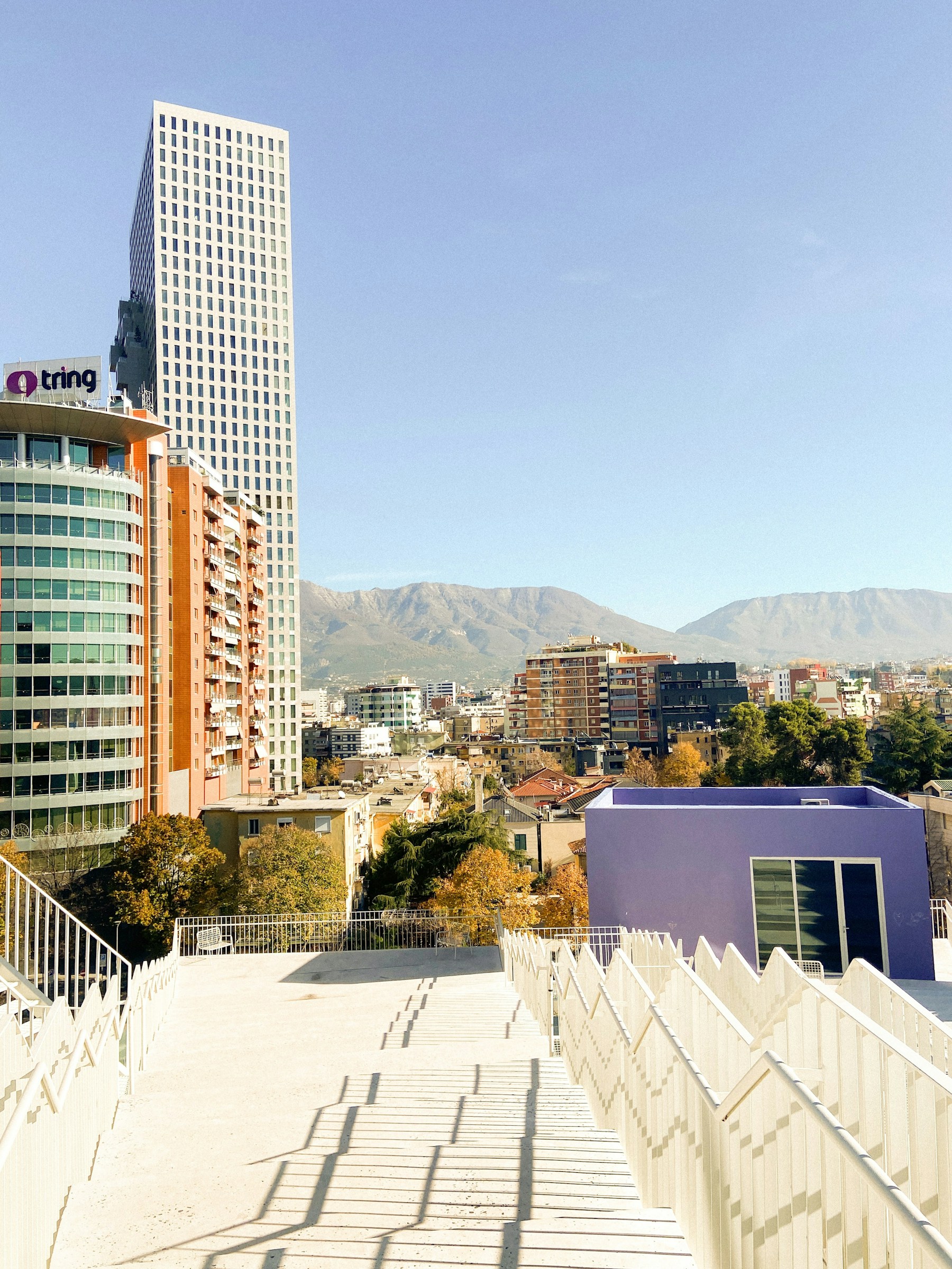 Tirana skyline with modern skyscrapers and mountains in the background